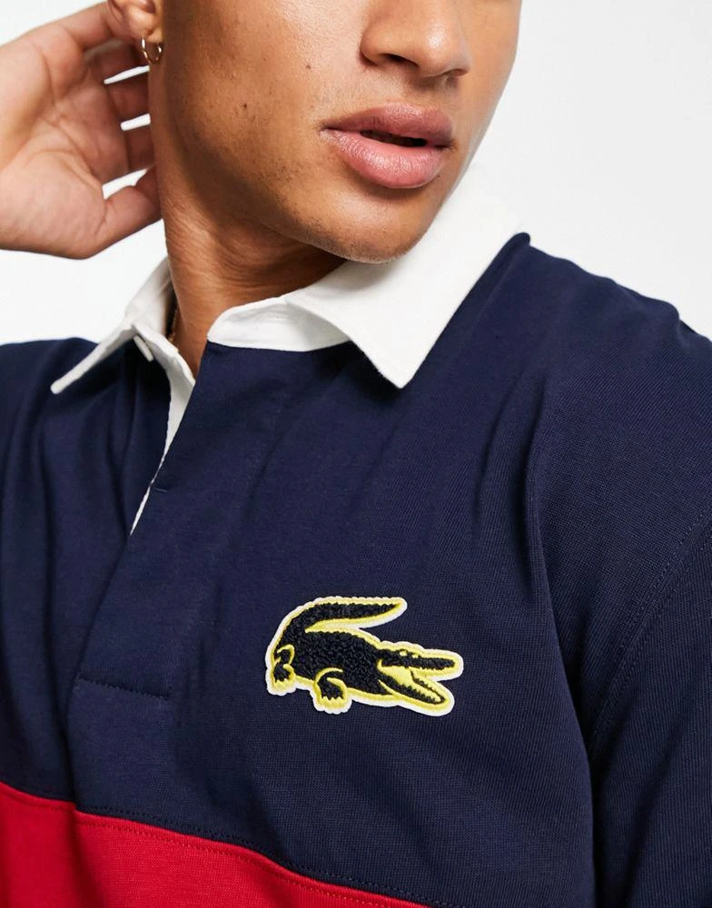 商品Lacoste|Lacoste striped rugby polo in navy/red,价格¥779,第3张图片详细描述