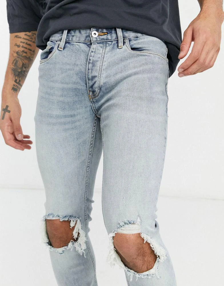 商品Topman|Topman skinny jeans with blow out knee rips in light wash blue,价格¥131,第3张图片详细描述