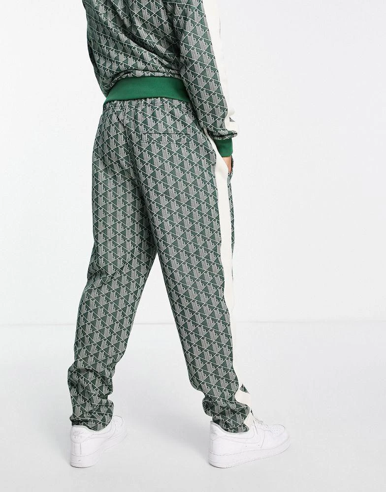 商品Lacoste|Lacoste all over print taped track bottoms in green,价格¥786,第2张图片详细描述