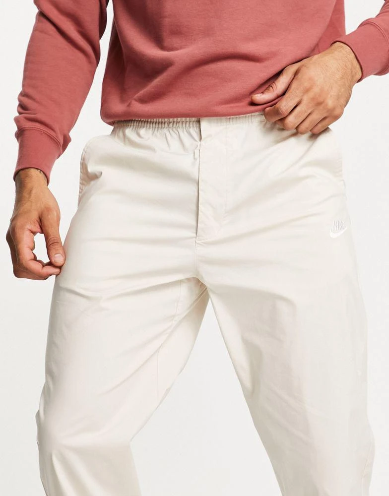 商品NIKE|Nike Sport Essentials cropped woven straight leg sneaker pants in stone,价格¥312,第4张图片详细描述