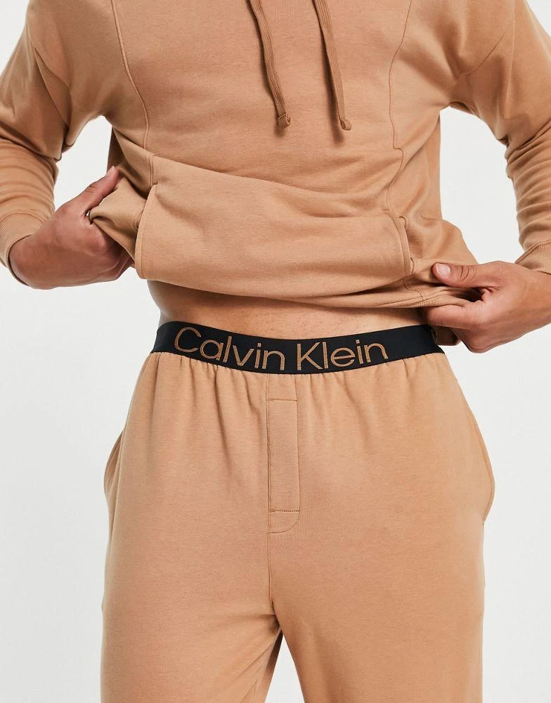 商品Calvin Klein|Calvin Klein contrast waistband lounge joggers in camel co-ord,价格¥441,第2张图片详细描述