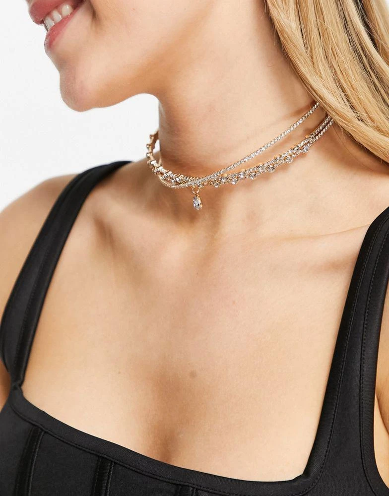 商品ASOS|ASOS DESIGN choker necklace with crystal cross over design and crystal pendant in gold tone,价格¥109,第2张图片详细描述