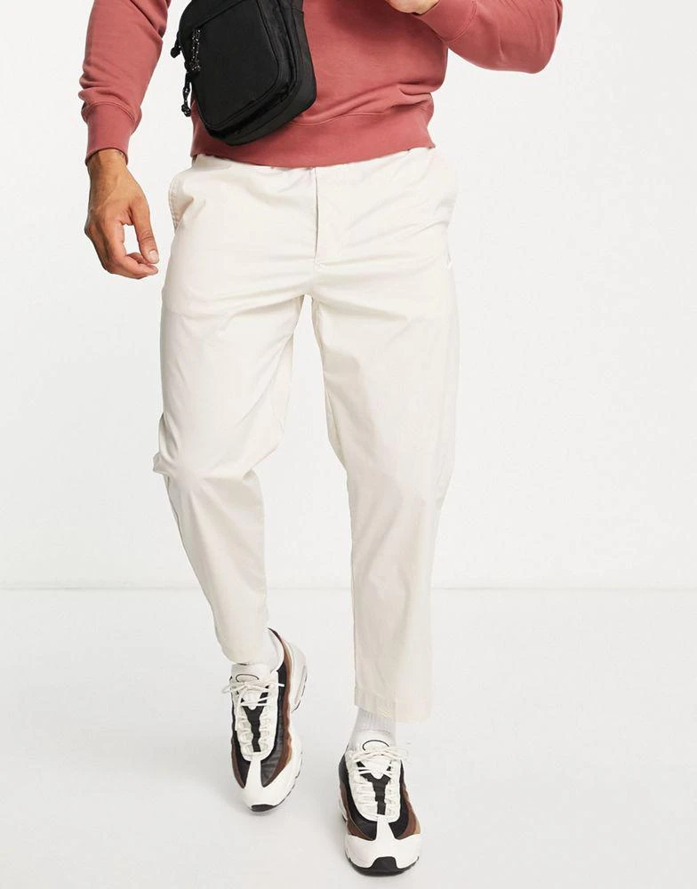 商品NIKE|Nike Sport Essentials cropped woven straight leg sneaker pants in stone,价格¥312,第1张图片