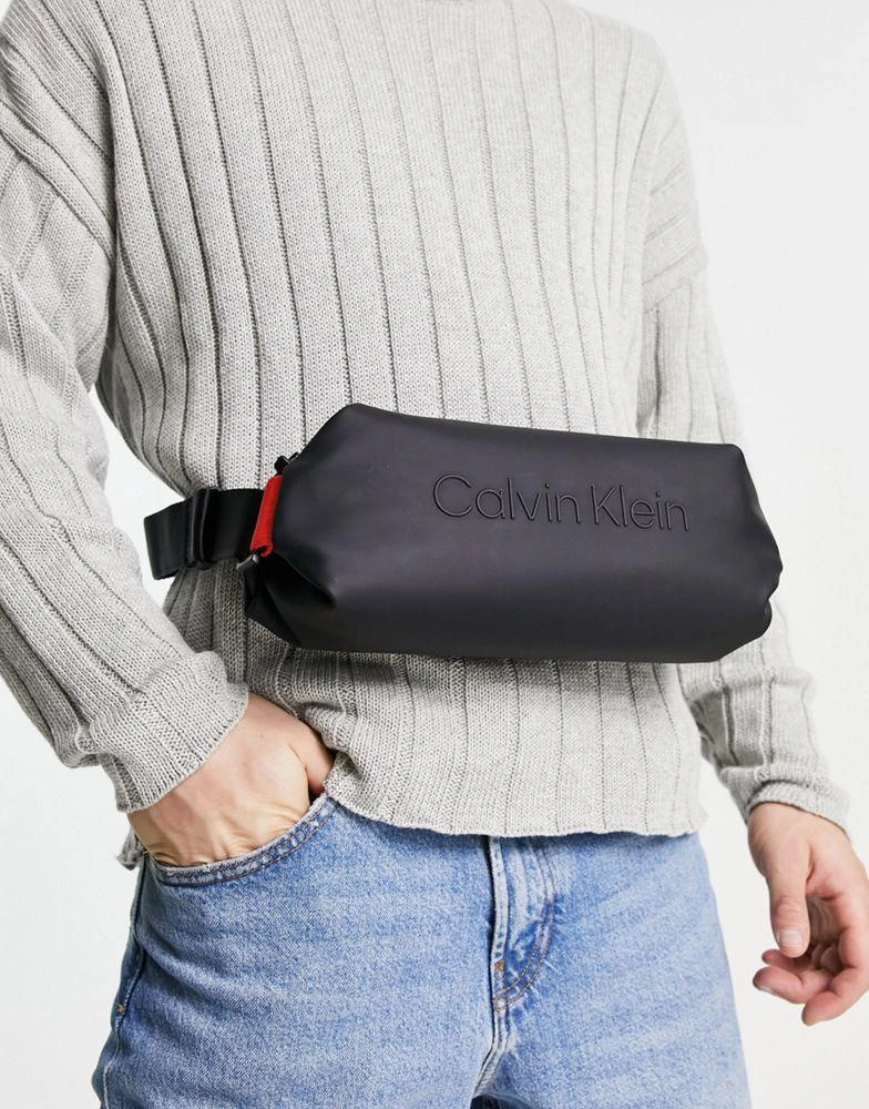 商品Calvin Klein|Calvin Klein rubberized bumbag in black,价格¥497,第2张图片详细描述