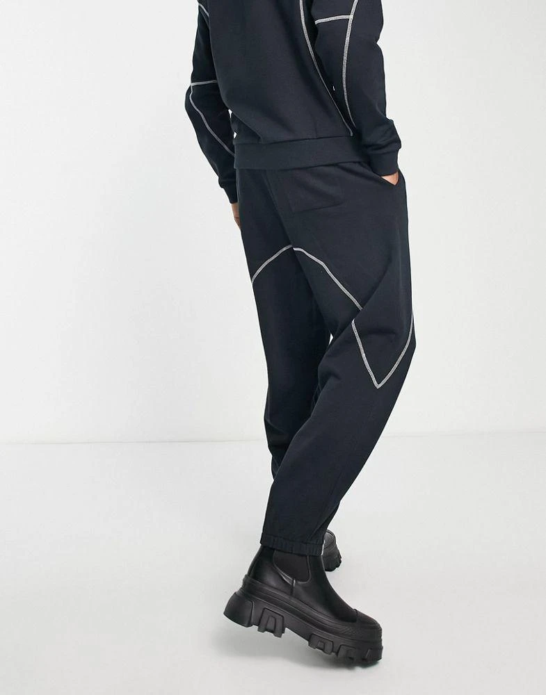 商品ASOS|ASOS DESIGN co-ord relaxed joggers in black with tattoo print and stitching detail,价格¥172,第2张图片详细描述