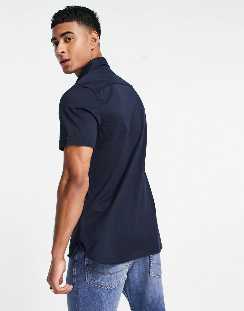 商品Tommy Hilfiger|Tommy Hilfiger 1985 icon logo short sleeve pique shirt slim fit in navy,价格¥700,第2张图片详细描述