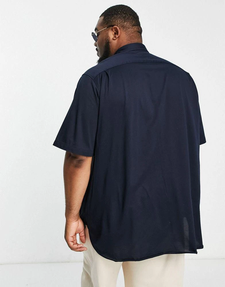 商品Tommy Hilfiger|Tommy Hilfiger Big & Tall 1985 icon logo short sleeve pique shirt in navy,价格¥742,第2张图片详细描述