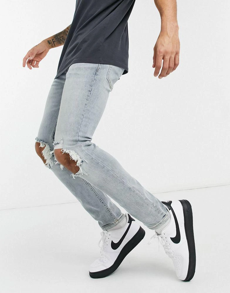 商品Topman|Topman skinny jeans with blow out knee rips in light wash blue,价格¥131,第4张图片详细描述