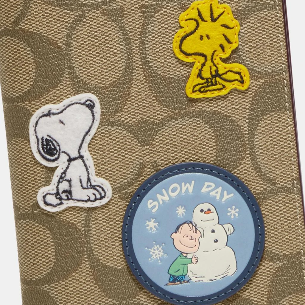 商品Coach|Coach Outlet Coach X Peanuts Passport Case In Signature Canvas With Patches,价格¥768,第2张图片详细描述