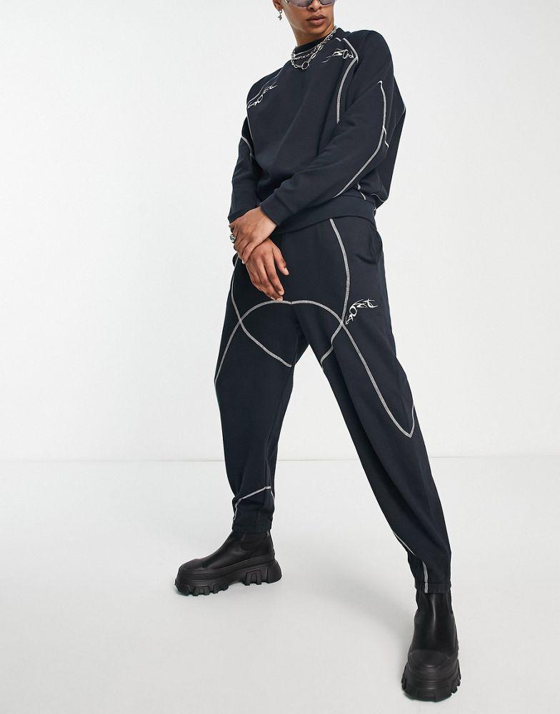 商品ASOS|ASOS DESIGN co-ord relaxed joggers in black with tattoo print and stitching detail,价格¥159,第1张图片