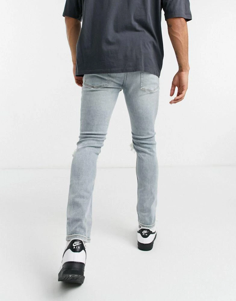 商品Topman|Topman skinny jeans with blow out knee rips in light wash blue,价格¥131,第2张图片详细描述