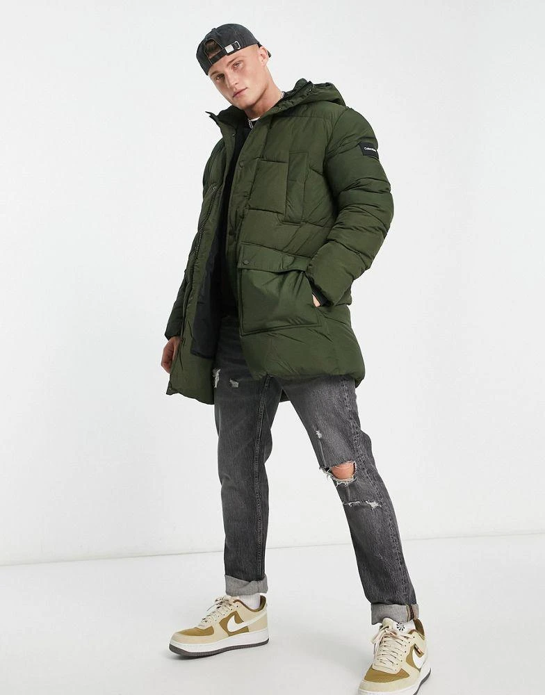 商品Calvin Klein|Calvin Klein crinkle nylon longline hooded puffer jacket in dark green,价格¥1877,第1张图片