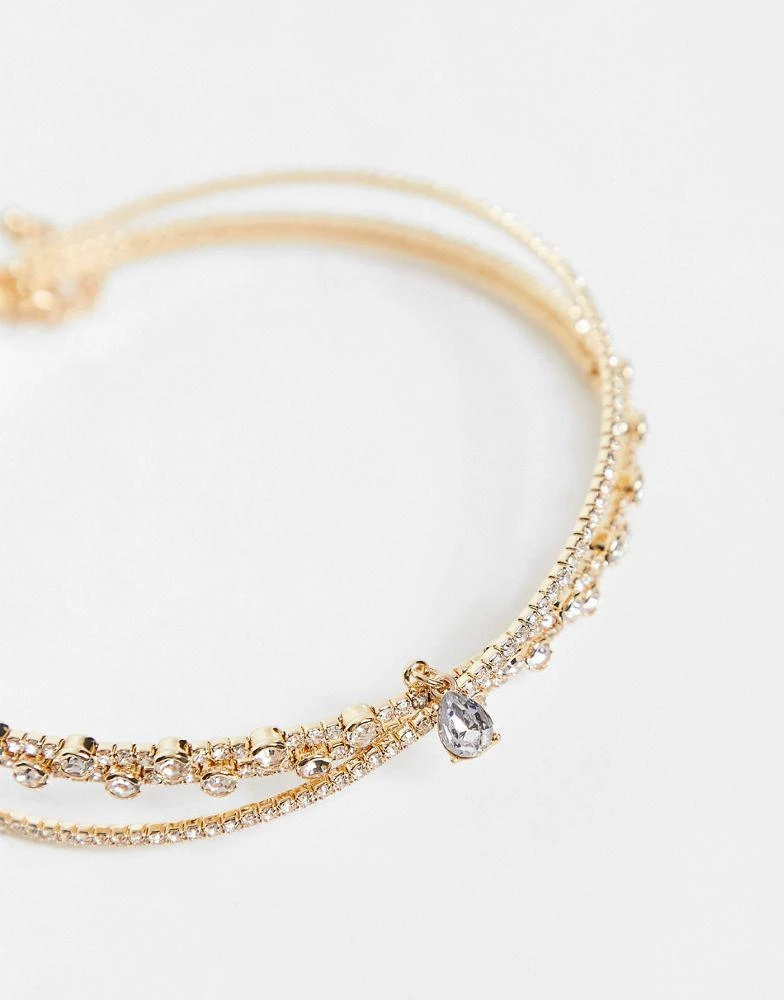 商品ASOS|ASOS DESIGN choker necklace with crystal cross over design and crystal pendant in gold tone,价格¥109,第3张图片详细描述