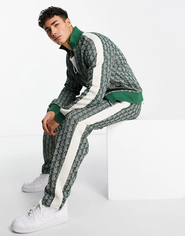 商品Lacoste|Lacoste all over print taped track bottoms in green,价格¥786,第1张图片