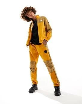 推荐The North Face NSE woven shell track joggers in yellow and brown商品